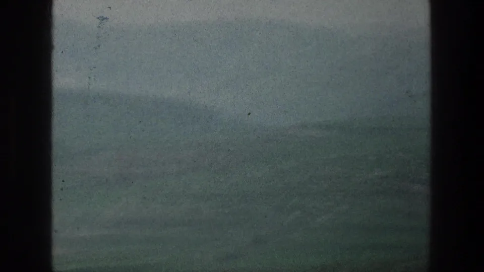 1976 8mm view of misty hills near the listed Jacobs Well Jerusalem, Israel location, framed by dark scan edges.