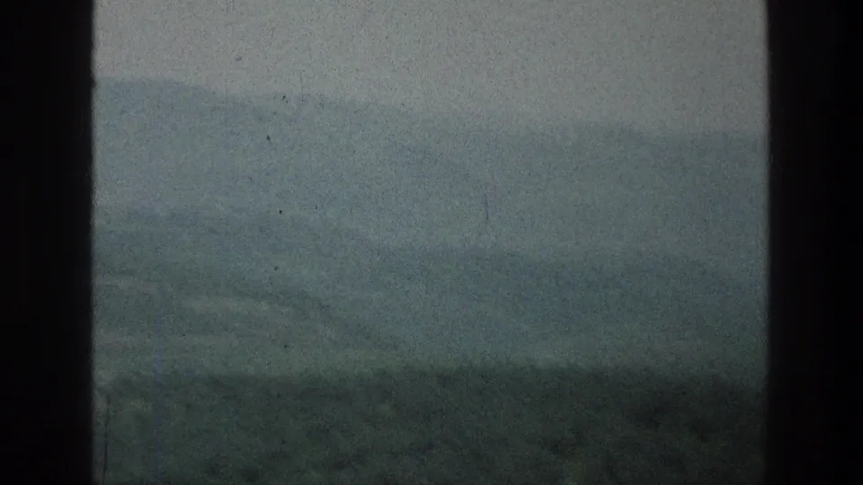 Muted 8mm landscape frame showing layered hills and haze at the listed Jacobs Well Jerusalem, Israel location.