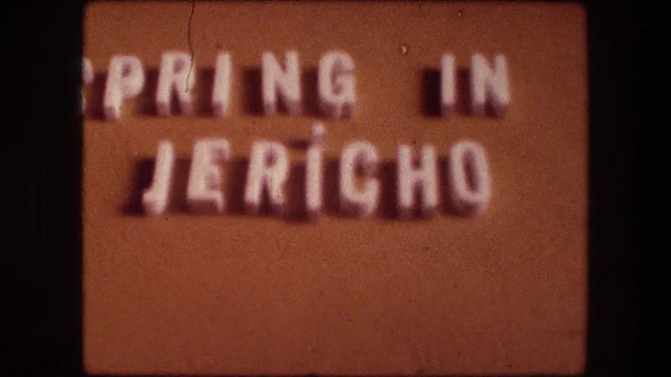 1976 8mm Jericho home-movie title card with raised white letters reading Spring in Jericho on a brown background.