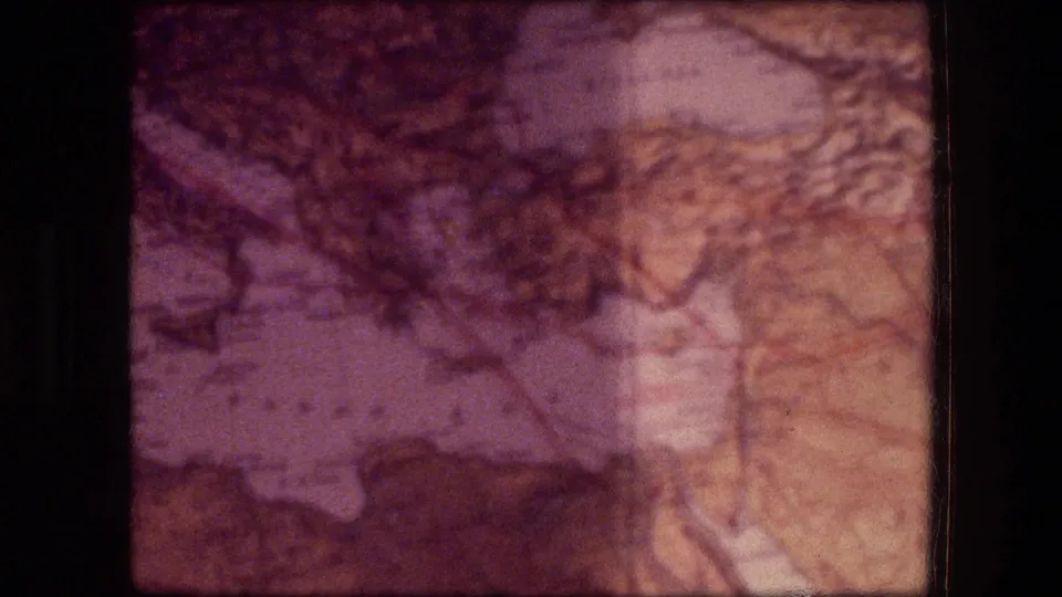 1976 Jericho-related 8mm frame showing a close map or location detail with faded color, dark patches, and a film-strip divider.