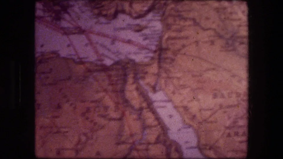 Final 8mm frame of the map close-up, likely connected to Jericho travel footage, with wrinkled paper and muted highlighted regions.