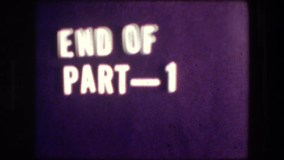 The clip closes on a purple 8mm title card reading END OF PART—1, framed by dark borders and visible grain.