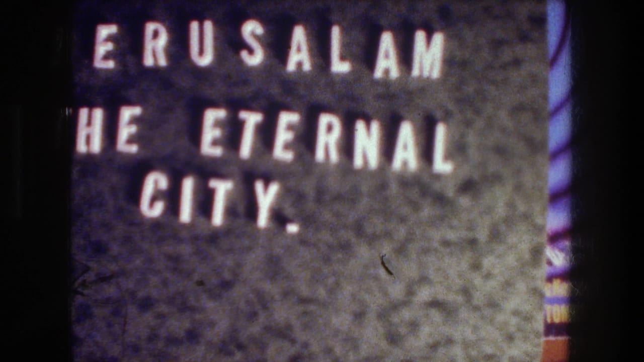 1976 Jerusalem travel-film title card with white block letters on a dark textured background and visible 8mm grain.