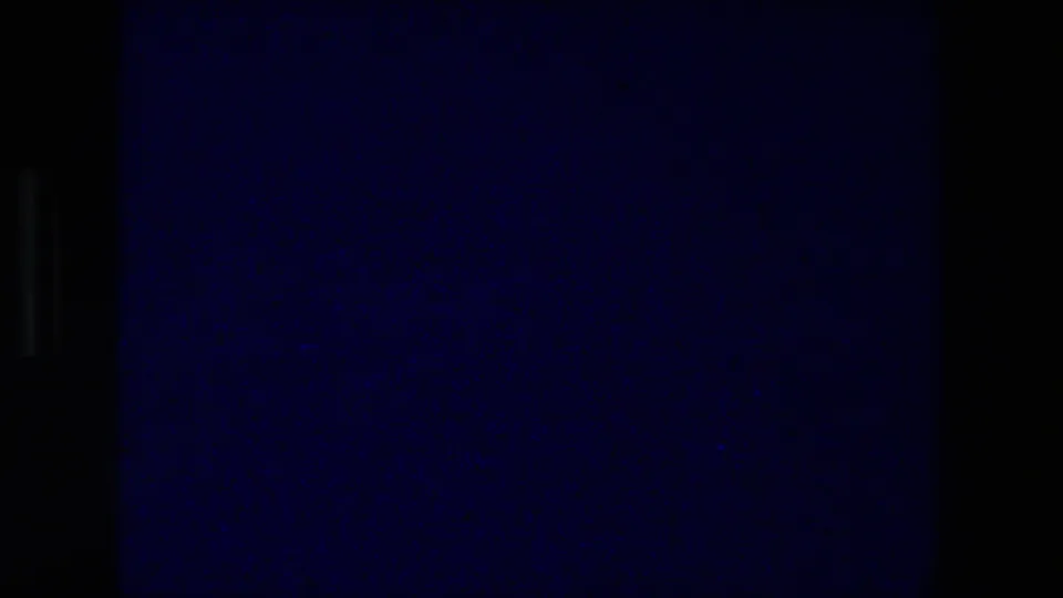 Lower contact-sheet frame is largely blue and underexposed, with film grain and dark borders visible but little scene detail.