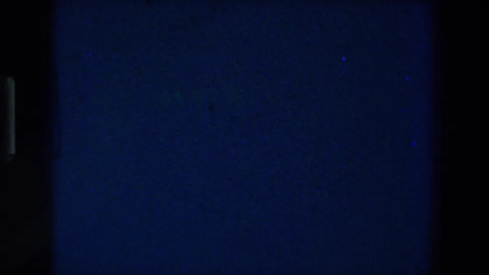 Final contact-sheet frame shows a mostly dark blue underexposed area with subtle grain and surrounding film-frame edges.
