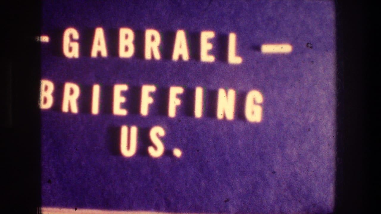 Blue 8mm title card from the Jerusalem reel with white block lettering reading "GABRAEL BRIEFFING US."