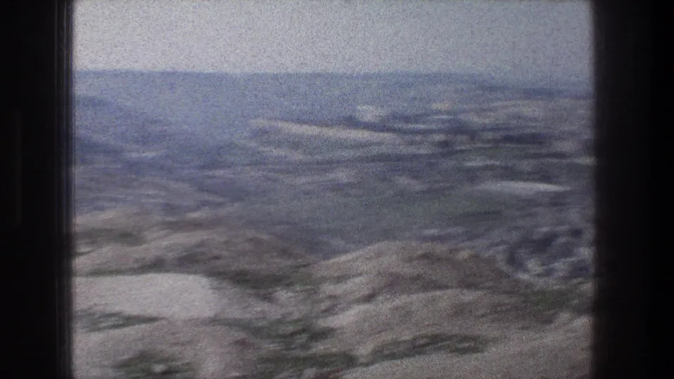 A soft 8mm view from the bus shows hazy terrain outside Jerusalem during the 1976 tourist trip.