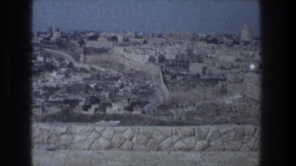 1976 8mm city panorama of Jerusalem from a stone overlook, with no person centered in the frame.