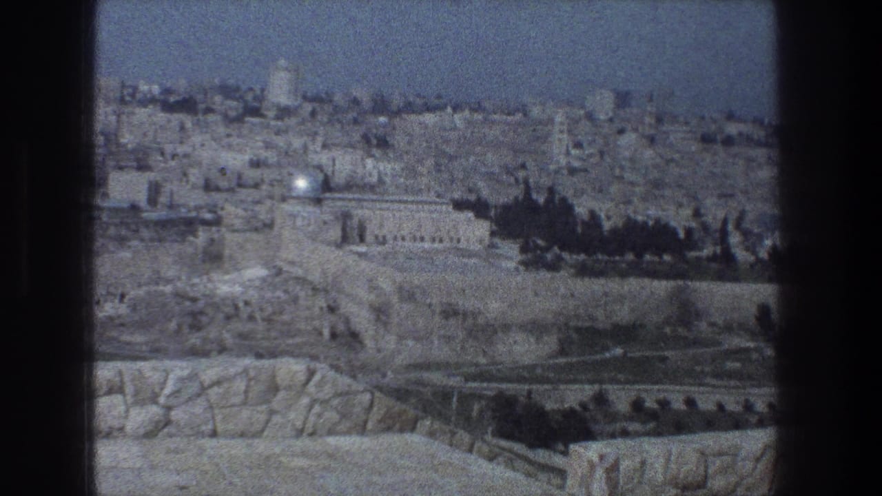 Distant Jerusalem cityscape with stone buildings and a domed landmark beyond terraced ground.