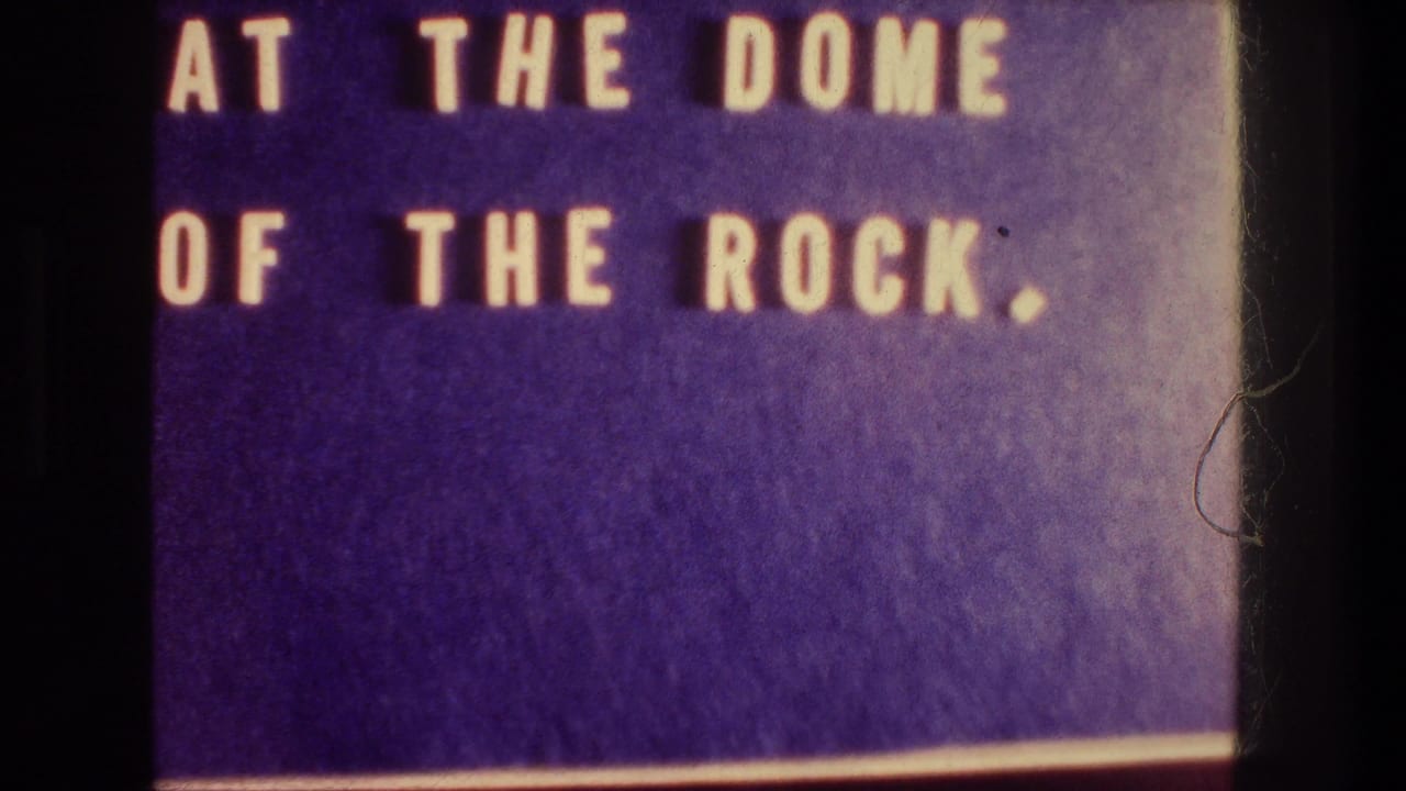 Title card reading AT THE DOME OF THE ROCK with film border visible.
