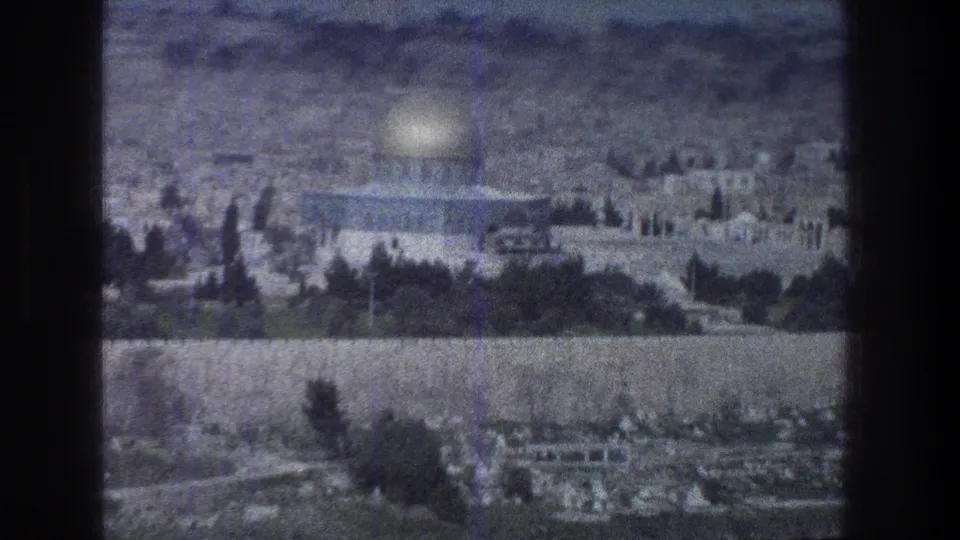 Soft 1976 8mm view of Jerusalem with the Dome of the Rock prominent beyond trees and stonework.
