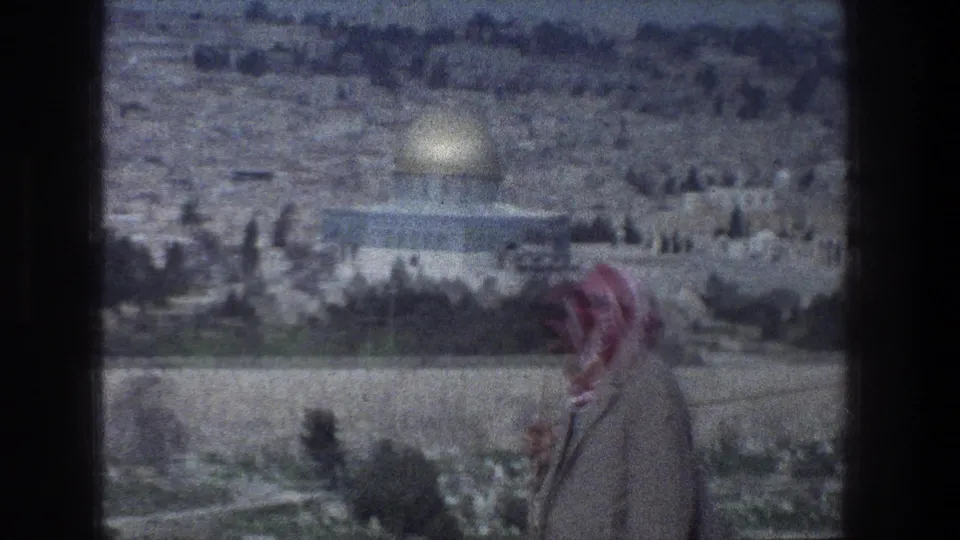 1976 8mm Jerusalem shot with a camel and rider crossing the foreground below the Dome of the Rock.