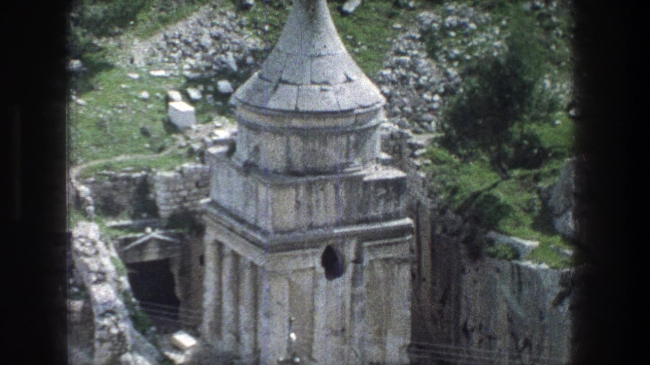 1976 Jerusalem frame of the same stone ruin, with its conical top, dark side entrance, broken masonry, and hillside vegetation.