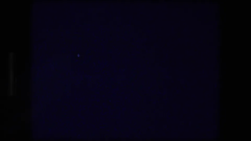 Nearly black 8mm transition frame, likely between the title card and the landscape view.