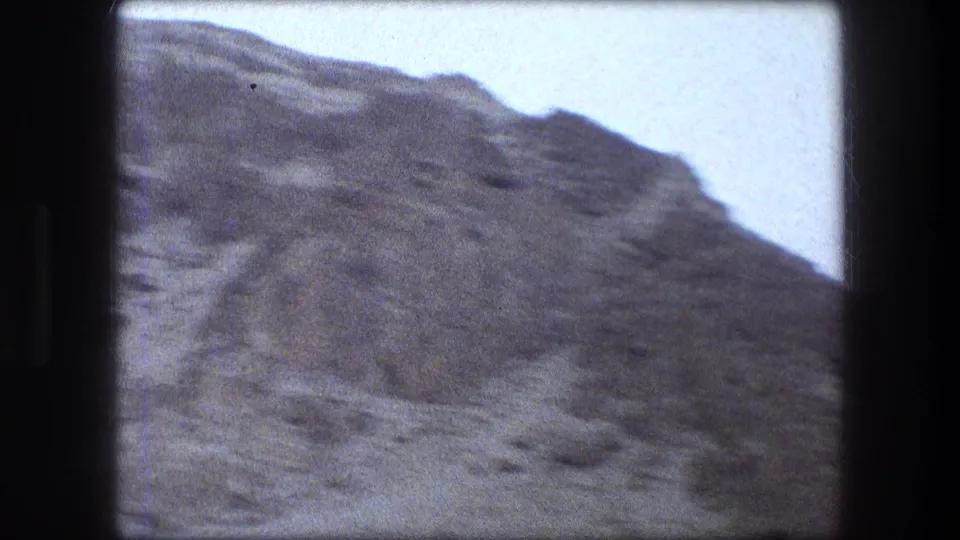 Messada, Israel travel footage shows a rugged arid hillside beneath a pale sky in soft 8mm grain.