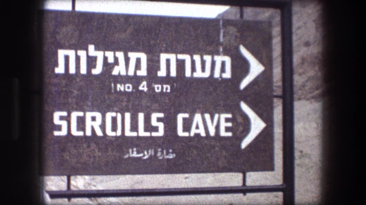 Close 1976 8mm view of a Scrolls Cave sign at Masada, with multilingual text and right-pointing arrows.