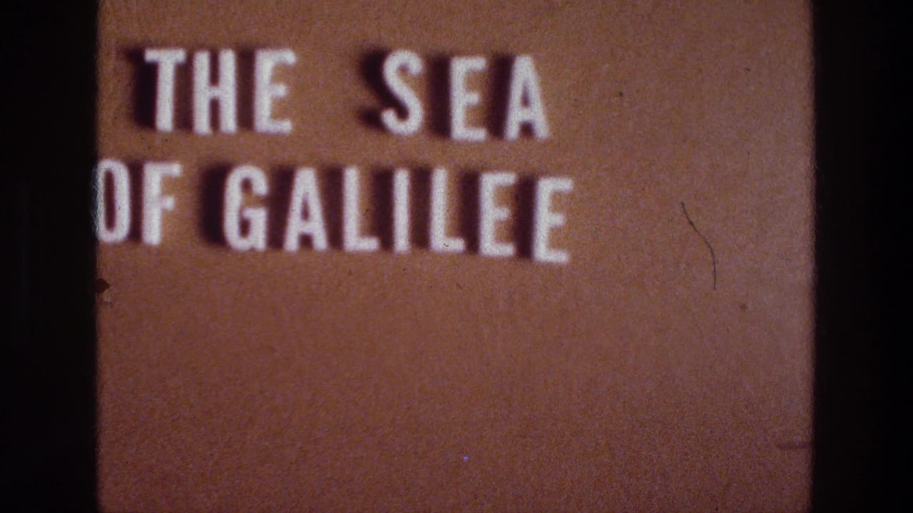 White title text reading THE SEA OF GALILEE projected on a brown surface.