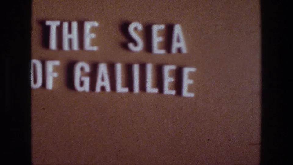 1976 8mm title card for the Sea of Galilee, with white block lettering on a brown projected-film background.