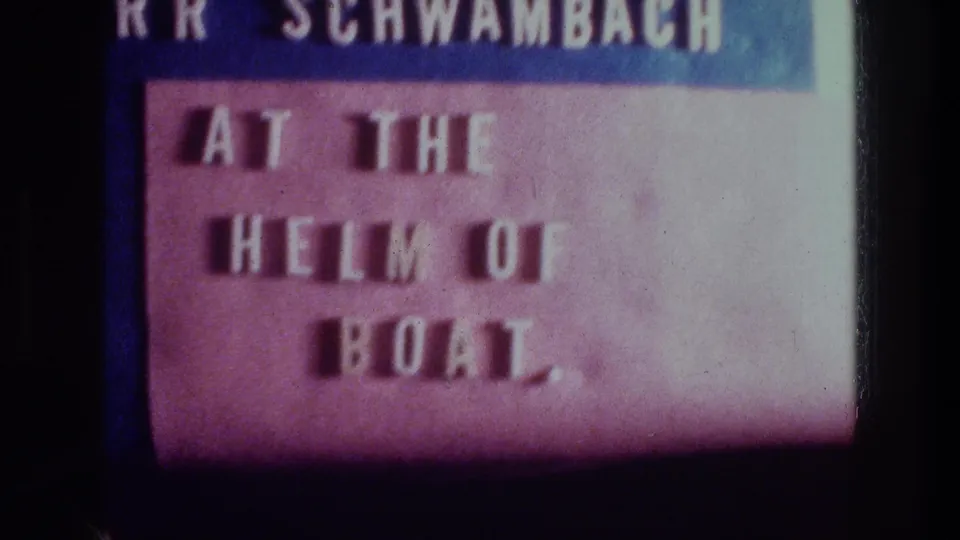 Projected 8mm frame repeats the boat title text, with faded purple tones and dark surrounding film border.