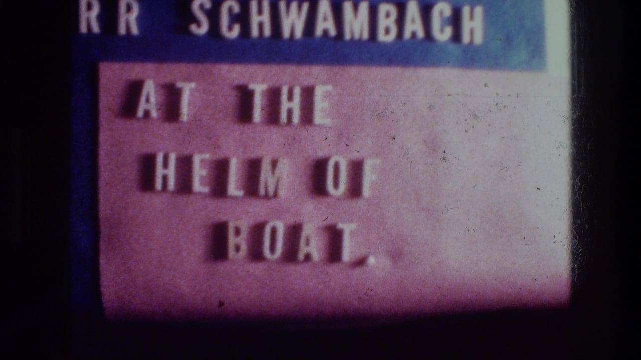 Title card reading “AT THE HELM OF BOAT” with a partial name above.