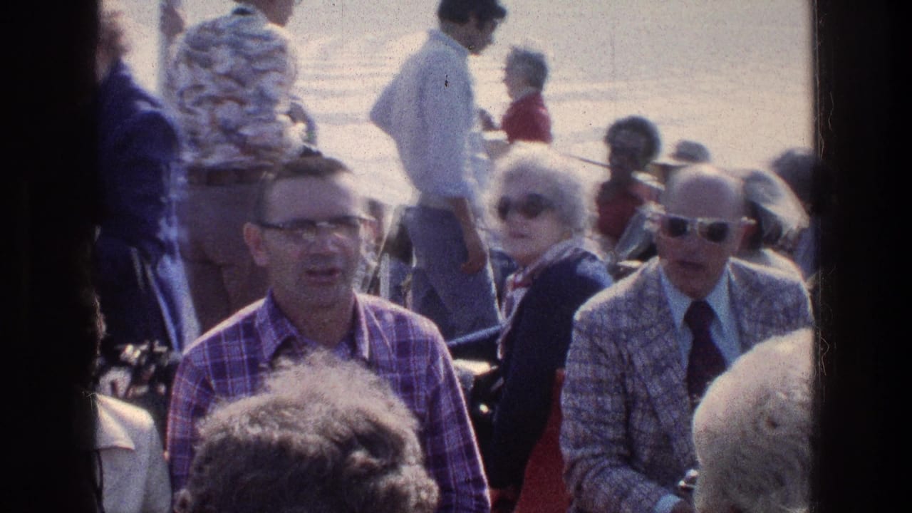Passengers seated on a crowded boat with water behind them.