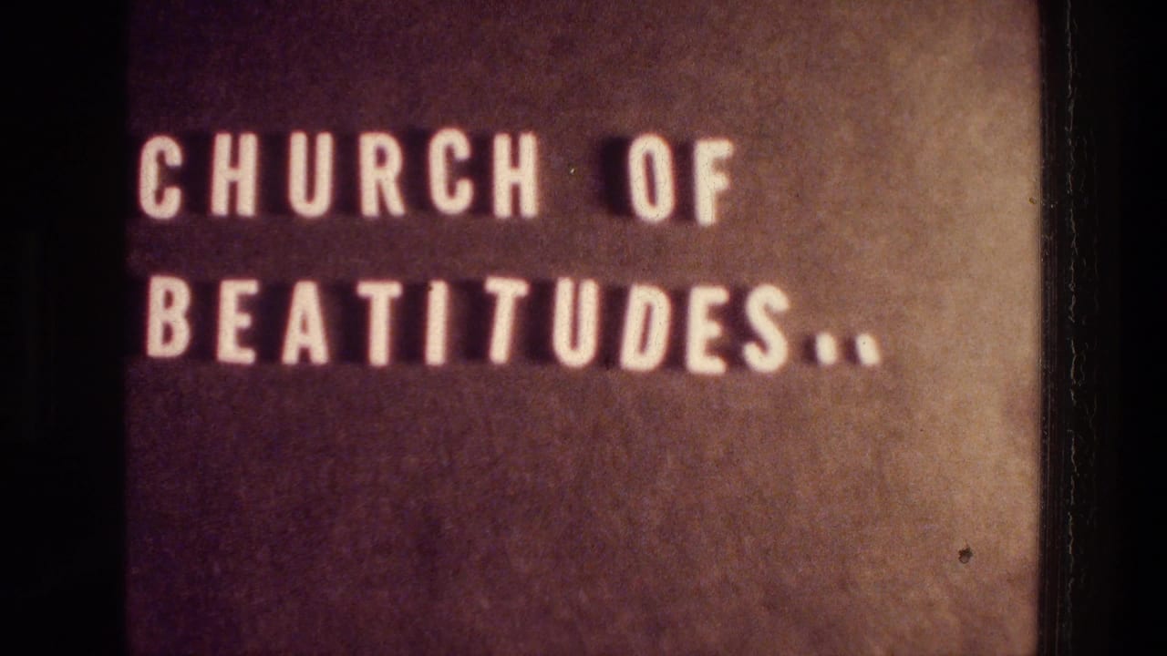 Static 1976 Tabgha frame of the Church of Beatitudes sign, with warm 8mm color and visible grain around the lettering.