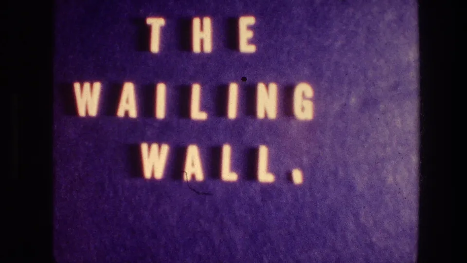 Close title-card frame from the 1976 Wailing Wall home movie, with large pale letters and a purple 8mm cast.