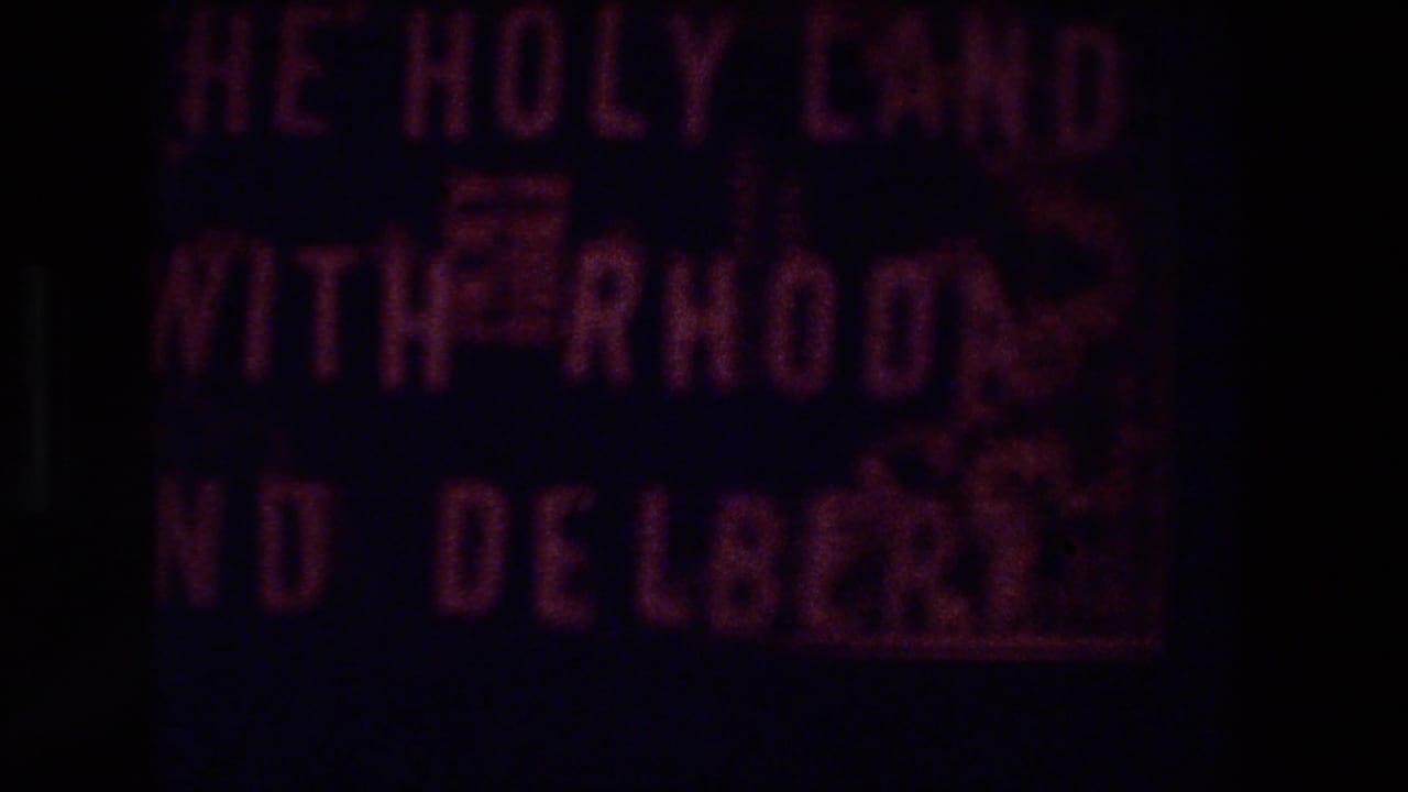 Dark frame with blurred pink title lettering.