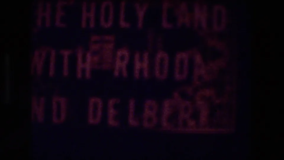 Pink hand-lettered title card on dark 8mm footage, likely introducing the Zurich 1976 segment.