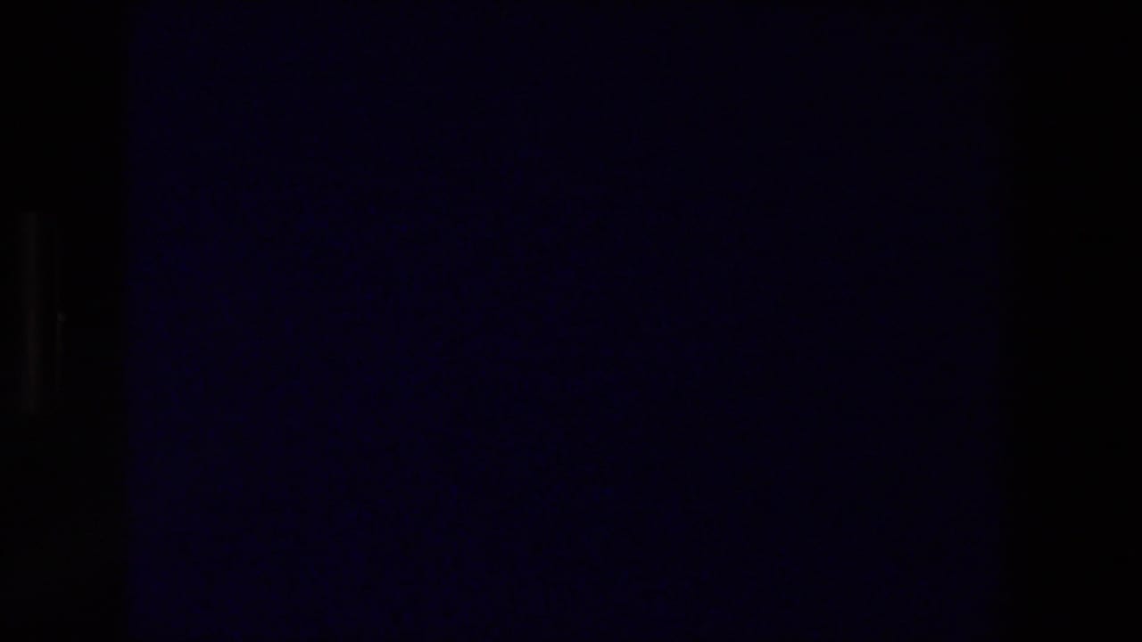 Mostly dark film frame with little visible detail before the Zurich title appears.