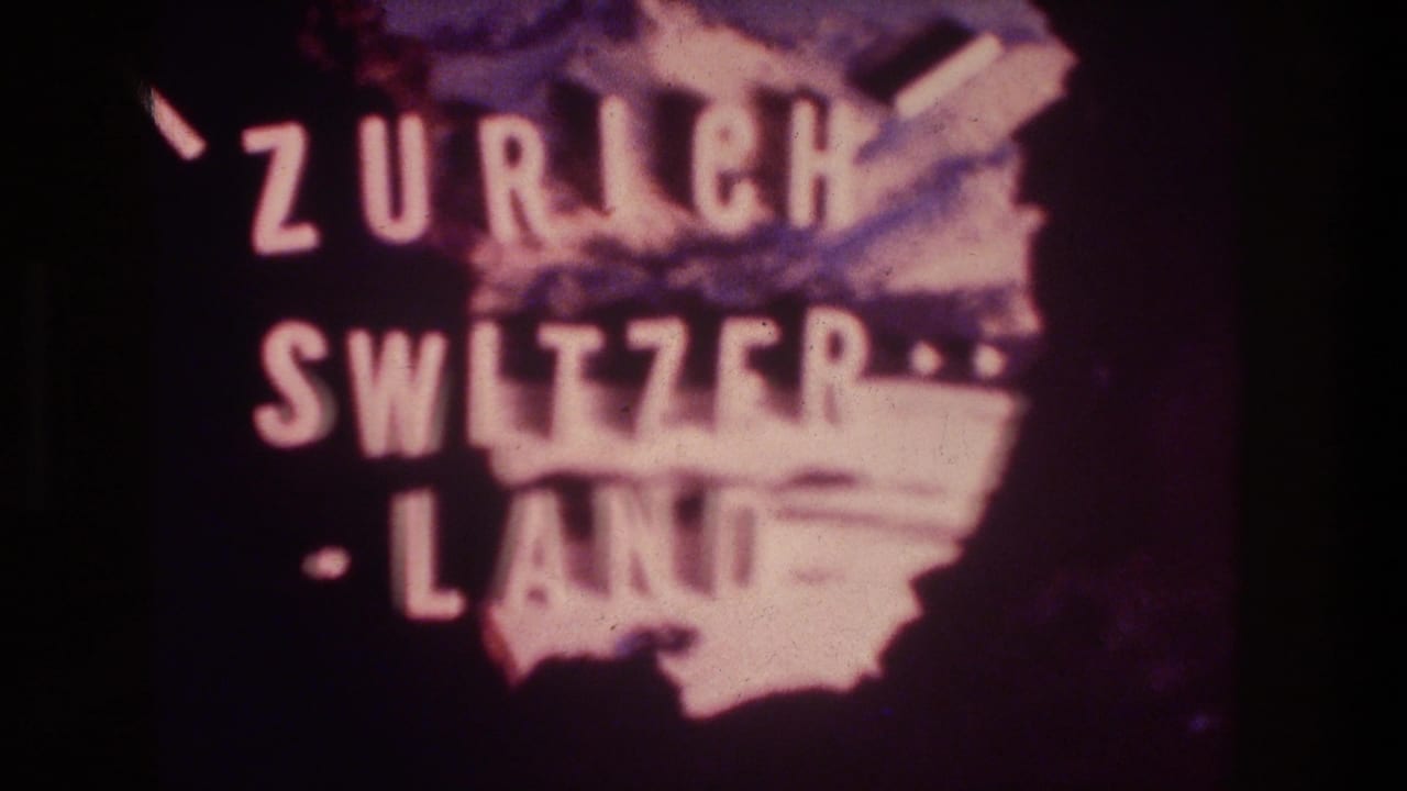 1976 8mm frame showing the Zurich Switzerland title card centered over a pink map silhouette with visible grain and fading.