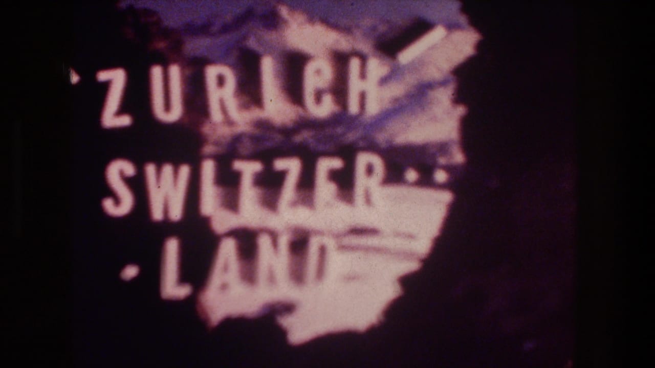 A second 1976 8mm view of the Zurich Switzerland projected card, showing white letters, purple tint, and dark surrounding screen area.