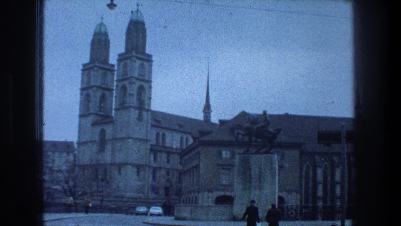 1976 Zurich home-movie view of Grossmunster, an equestrian statue, cobblestones, and distant pedestrians.