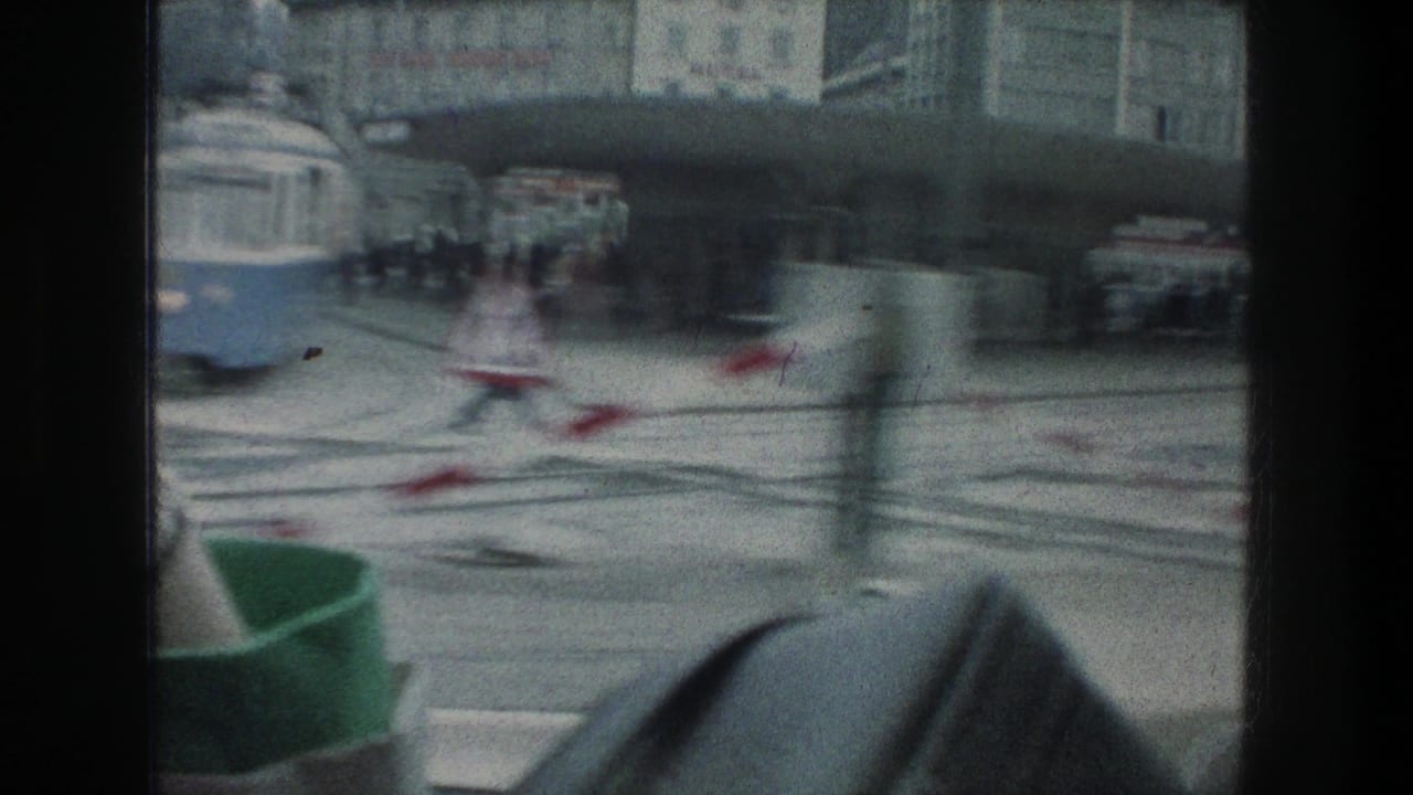 Motion-blurred 1976 Zurich street view with tram tracks, a partial tram, pedestrians, cars, and red-and-white barriers.