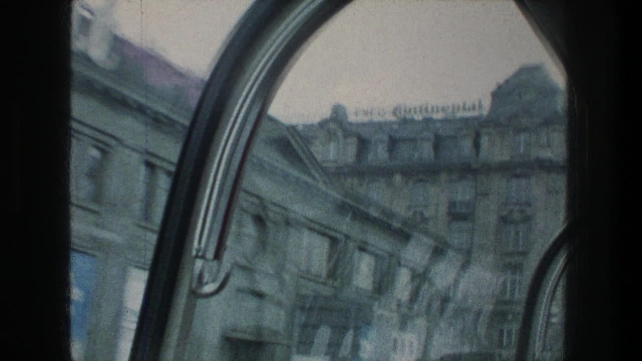 1976 Zurich travel footage showing a stone building facade through a curved vehicle window, with a rooftop Continental sign visible.