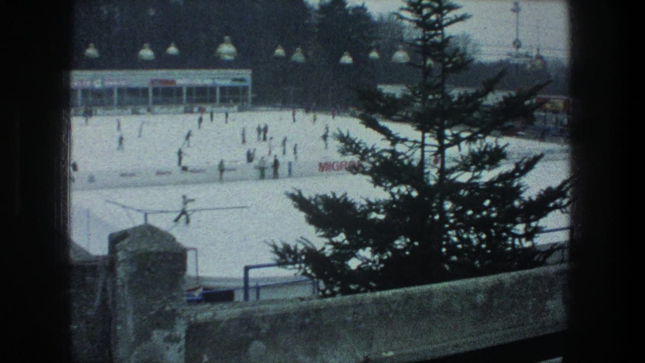 1976 Zurich winter rink scene framed by a pine tree and stone wall, with small skater figures, overhead lamps, signage, and a low rink building.