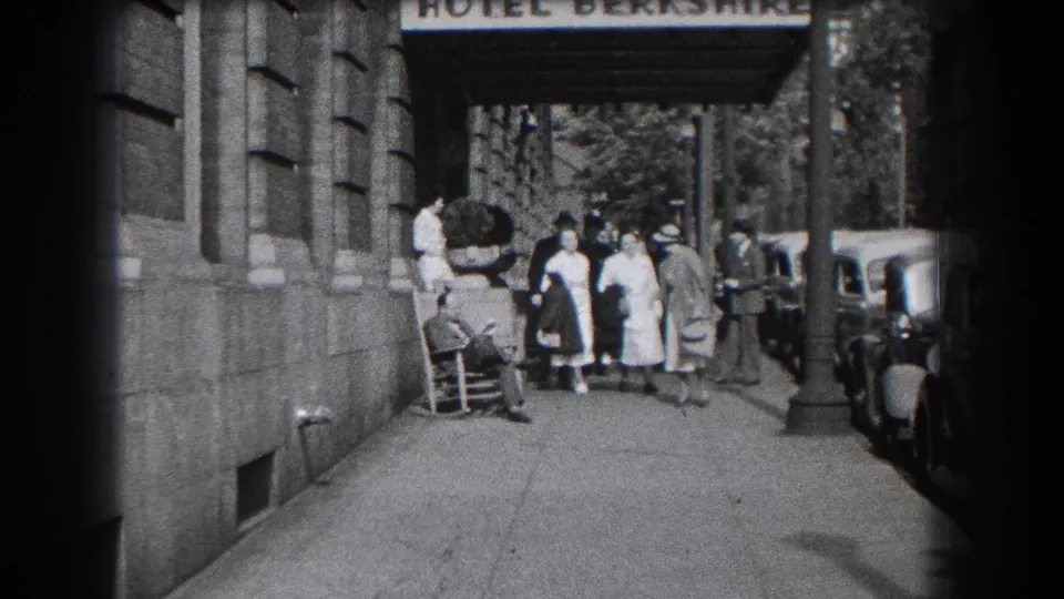 1938 Reading, Pennsylvania home-movie frame showing women leaving the Hotel Berkshire entrance with parked cars along the curb.