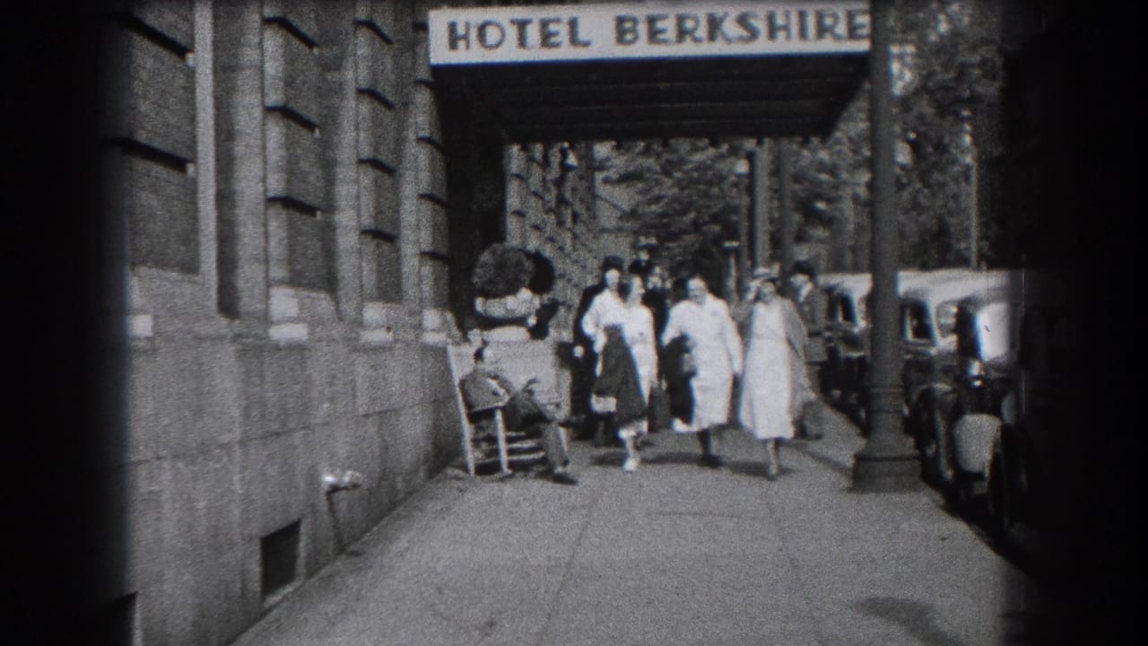 A group of women walks forward under the Hotel Berkshire awning with cars at the curb.