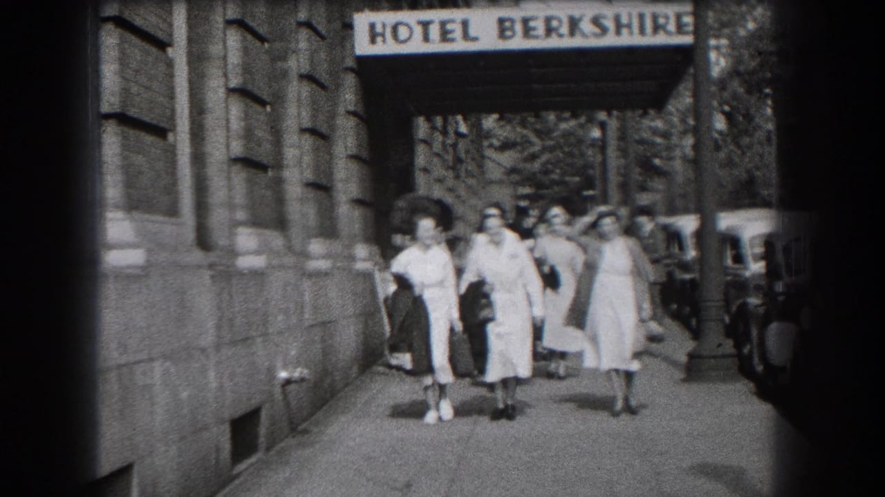 1938 Reading, Pennsylvania home-movie frame showing women in nurse-style white uniforms walking past the Hotel Berkshire entrance.