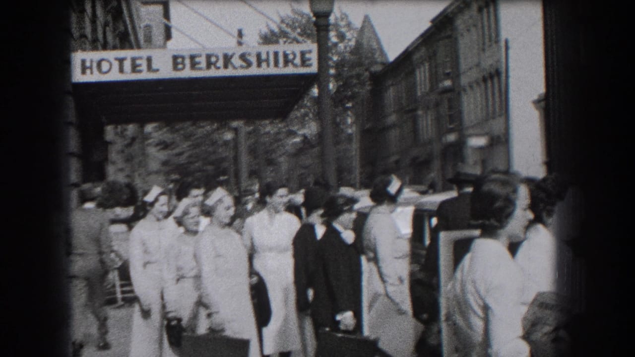 Group gathered under the Hotel Berkshire sign in Reading, with uniformed women, suited men, cars, and city buildings visible.
