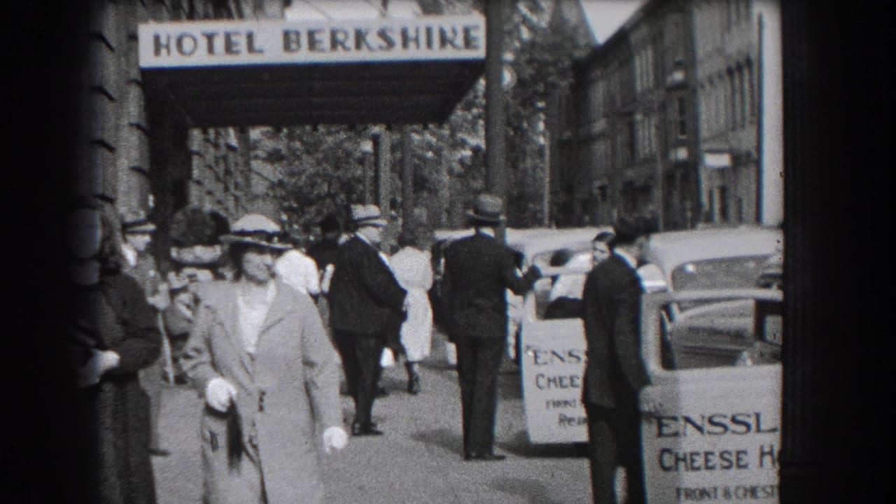 1938 Reading, Pennsylvania street view with pedestrians, parked automobiles, Hotel Berkshire signage, and an Enssler Cheese House vehicle.