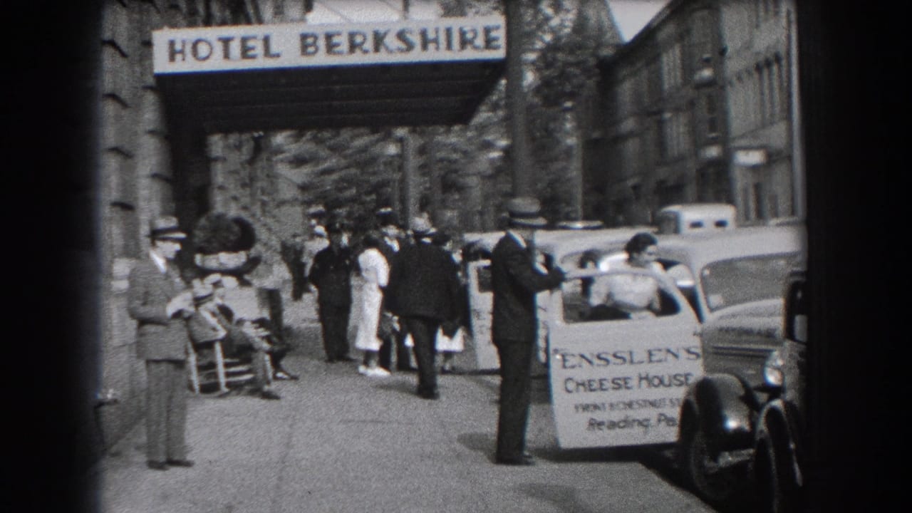 1938 Reading, Pennsylvania street view outside Hotel Berkshire with pedestrians, parked cars, and an Ensslen's Cheese House sign.