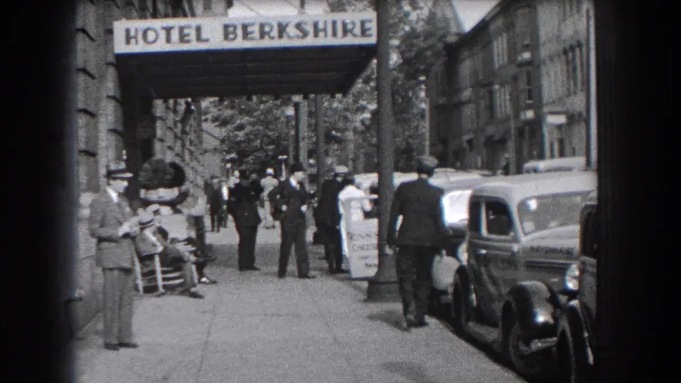 Reading, Pennsylvania hotel-front street scene with pedestrians under the Hotel Berkshire awning and prewar cars parked along the curb.