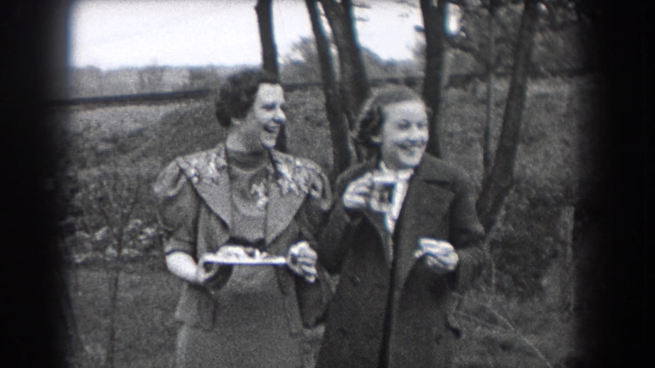 In 1938 Reading, Pennsylvania home-movie footage, two women stand outdoors smiling, with a tray and drinking glass visible.