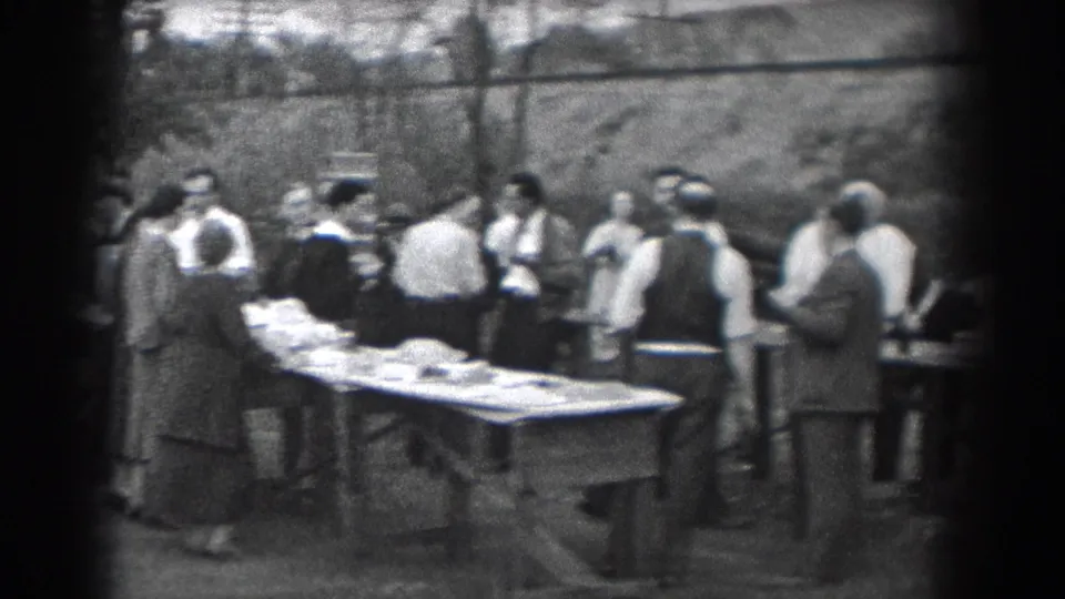 Outdoor Reading, Pennsylvania gathering in 1938, with adults in shirts, vests, coats, and skirts beside tables of food.