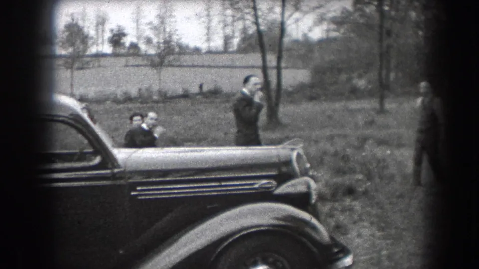 End frame shows adults and a child near a parked 1930s car, with another figure at the right edge of the outdoor Reading, Pennsylvania scene.