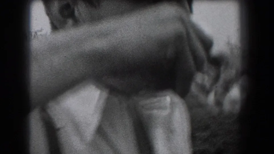 In 1938 Reading, Pennsylvania home-movie footage, a man in a white shirt begins drinking from a glass bottle outdoors.
