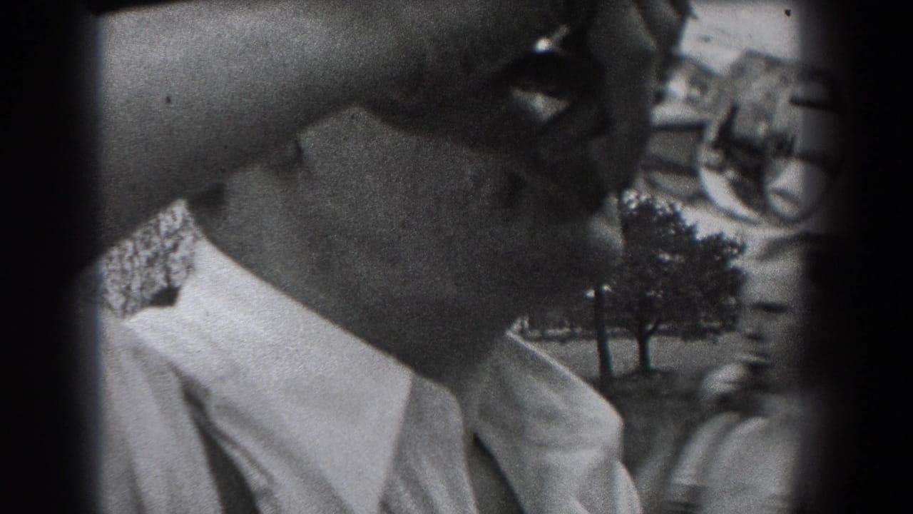 Close side view of a man drinking from a glass bottle outdoors.