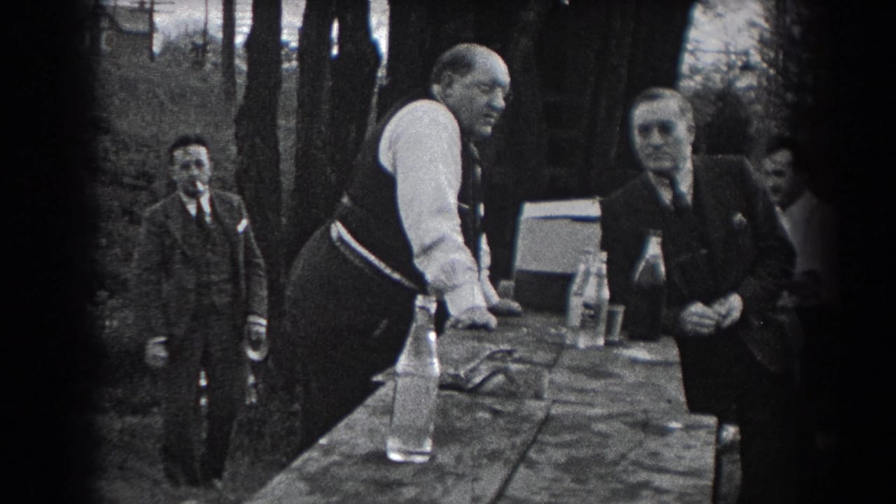 Reading, Pennsylvania home-movie frame from 1938 showing men in suits and vests beside an outdoor table with bottles.