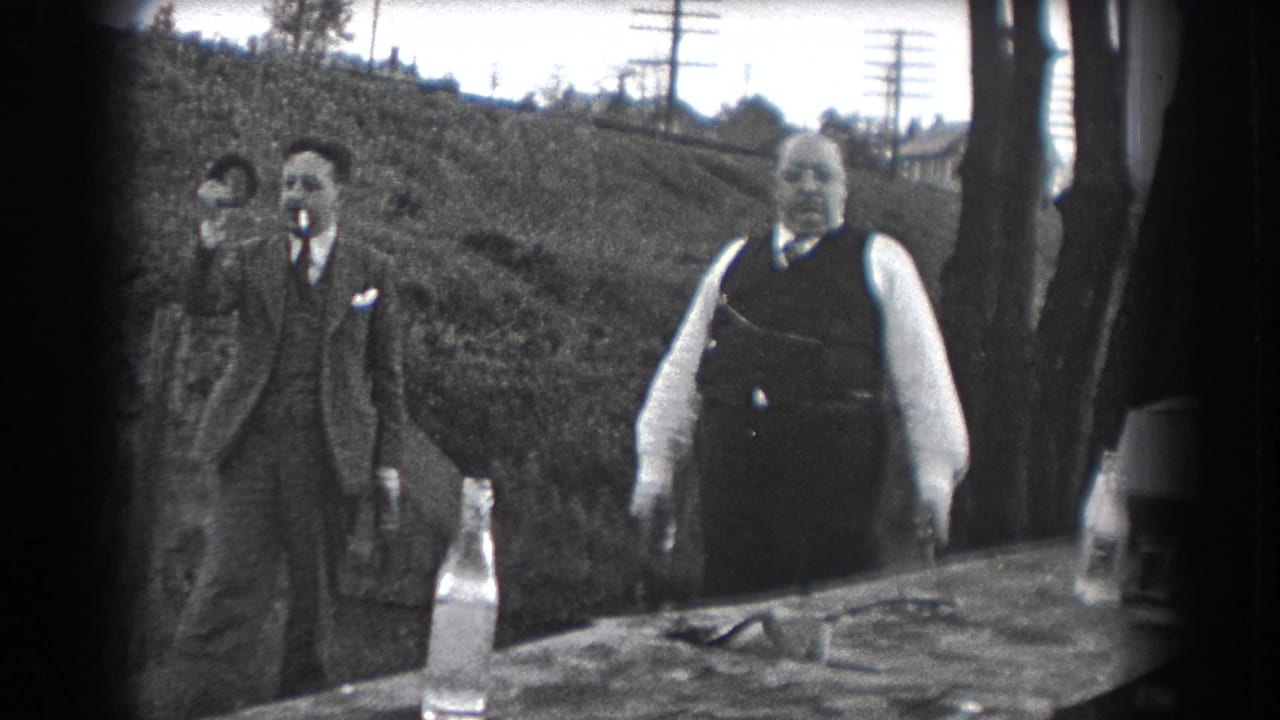 A 1938 Reading, Pennsylvania outdoor scene shows suited men socializing near a table, with one man smoking.